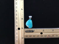 Navajo handcrafted sterling silver pendant with genuine turquoise stone.  LZ291