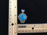 Navajo handcrafted sterling silver pendant with genuine turquoise stone.  LZ302