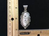 Navajo handcrafted sterling silver and White Buffalo Stone, 2.5” top to bottom. LZ091B