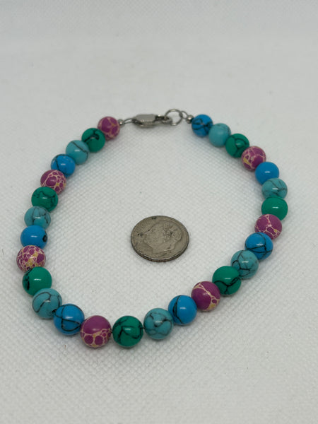 EP166. Ankle bracelet with turquoise and pink color stones with a hypoallergenic  stainless steel clasp.   Free Shipping in con’t USA.