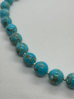 Turquoise (restructured blue) 12 mm stone necklace with sterling silver saucer beads, 20” long.  SR2083 FREE SHIPPING IN THE CONTINENTAL USA.