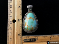 Navajo Handcrafted sterling silver, genuine turquoise, 2.25” top to bottom, LZ090