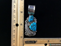 Navajo handcrafted sterling silver and genuine turquoise pendant, 2.5” top to bottom.  LZ102