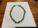 Green turquoise necklace in 17.5” length.  The stones are dyed to resemble natural  Gaspeite.  The stones are alternated  with  Navajo hand soldered sterling silver  beads .   A.S.   GT-1