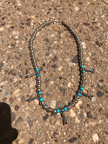 Handcrafted sterling silver and grade AA Kingman turquoise necklace with squash blossom beads. Approximately 20”