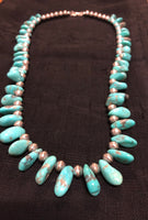 Genuine and natural color Campitos turquoise teardrop necklace with etched Aztec design sterling silver beads and lobster claw clasp. 25”.  A.S.    CAMP-2 FREE SHIPPING IN THE CONTINENTAL USA.