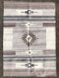 This handwoven rug is a design inspired by Navajo rugs. It has several tones from the lightest grey to a medium grey.