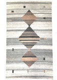 This grey tone background handwoven rug has some shades of grey along with three diamonds, two of them with a touch of mauve.