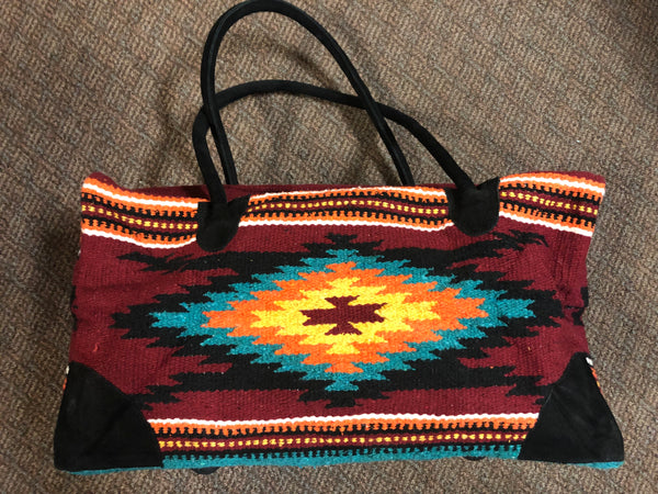 Handwoven recycled acrylic Southwest style weekender bag.  22” x 10” x 12” high.
