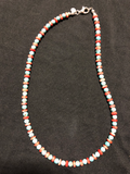 Round natural turquoise beads with alternating discs of Spiney oyster shell  and a sterling silver clasp. 18” long.