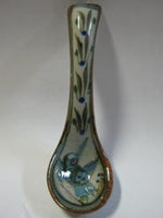 Ken Edwards Spoon (U117A) with  green, two shades of blue and brown flowers, birds, and butterflies decorated on the side or inside on bowls or plates.