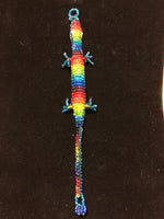 Guatemalan made glass bead gecko bracelet where the mouth is one end of the bracelet and the tail is the other end making a wrap around the wrist bracelet.