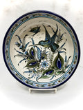 Hummingbird in blue rim bowl