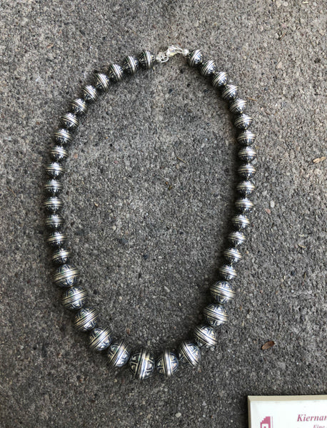 Navajo Pearl style sterling silver bead necklace in 4 sizes of beads, decorated with flowers in a 20” length.  By A.S.   AS613