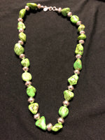 This green turquoise and Navajo sterling silver bead necklace was dyed to resemble Natural Green Gaspeite.  It is 17.5” in length and has sterling silver beads and a sterling silver hook and latch clasp.