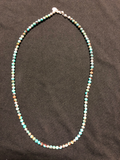 Natural turquoise and sterling silver bead necklace with lobster claw clasp.
