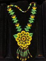 Green and yellow seed beads in floral necklace.