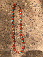 Genuine turquoise with red coral and sterling silver clasp.  18” long by A.S.    AS 603