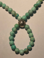 Light green/blue turquoise round bead with a Biuddhist central bead in sterling silver