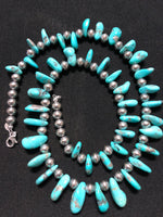 Genuine and natural color Campitos turquoise teardrop necklace with etched Aztec design sterling silver beads and lobster claw clasp. 25”. A.S.