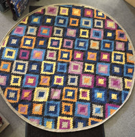 a 6 foot round rug in geometrics with lots of color