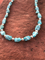 Campitos turquoise in a matte finish with sterling silver fashioned into a 20” necklace.  SR115