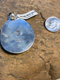 Turquoise stone pendant handcrafted in sterling silver.