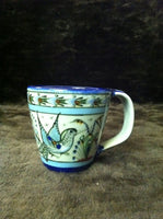 Ken Edwards Collection series Mug with  green, two shades of blue and brown flowers, birds, and butterflies decorated on the side or inside on bowls or plates