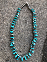 Genuine and natural color Campitos turquoise teardrop necklace with etched Aztec design sterling silver beads and lobster claw clasp. 25”.  A.S.    CAMP-2 FREE SHIPPING IN THE CONTINENTAL USA.