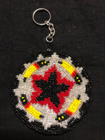 Round change purse with key ring covered in handbeaded glass beads.