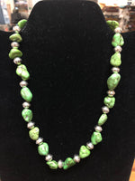 Green turquoise necklace in 17.5” length.  The stones are dyed to resemble natural  Gaspeite.  The stones are alternated  with  Navajo hand soldered sterling silver  beads .   A.S.   GT-1