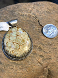 Turquoise stone pendant handcrafted in sterling silver.
