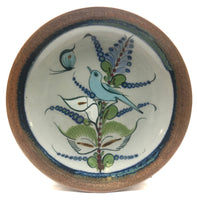 Ken Edwards Stoneware Pottery buffet plate with  green, two shades of blue and brown flowers, birds, and butterflies decorated on the side or inside on bowls or plates