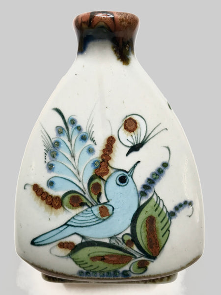 Triangular shape vaxe with bird and butterfly on exterior, both sides.