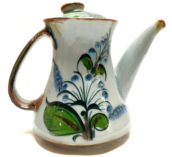 Coffee pot in stoneware with grey background and blue and green flowers