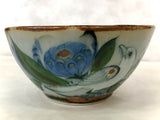 Ken Edwards Stoneware Pottery bowl with green, two shades of blue and brown flowers, birds, and butterflies decorated on the side or inside on bowls or plates 