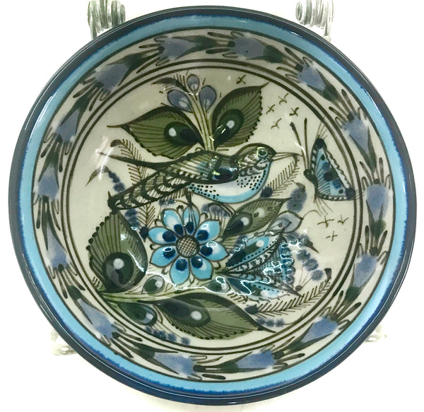 This 5" Ken Edwards collection series dessert bowl or can be used as an individual vegetable serving bowl.  It is natural grey clay color background with birds, butterflies, and leaves in blue, green, black and brown on the outside. 