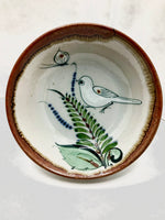 Ken Edwards v-7 cereal or soup bowl has a brown rim and a light grey background.  it has birds or butterflies and leaves decorated on the bowl inside only.