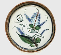 Ken Edwards round stoneware tray with green, two shades of blue and brown flowers, birds, and butterflies decorated on the side or inside on bowls or plates
