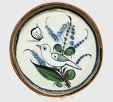 Ken Edwards round stoneware tray with green, two shades of blue and brown flowers, birds, and butterflies decorated on the side or inside on bowls or plates