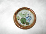 Ken Edwards Coaster (N1) brown rim with green and blue birds and leaves.