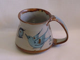 Ken Edwards Mug Flared (T4) with  green, two shades of blue and brown flowers, birds, and butterflies decorated on the side or inside on bowls or plates