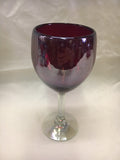Solid Red hand blown wine glass with clear glass stem and foot.