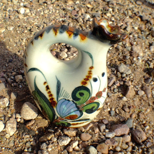 pitcher with handle and brown rim with bird.