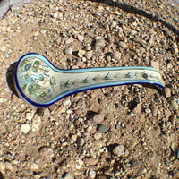 Ken Edwards Stoneware Pottery ladle with green, two shades of blue and brown flowers, birds, and butterflies decorated on the side or inside on bowls or plates 