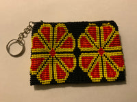Handcrafted beadwork on both sides of change purse with 2 flowers