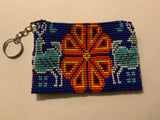 Handcrafted beadwork on both sides of change purse with 2 deer