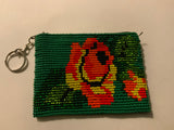 Handcrafted beadwork on both sides of change purse with Green flower