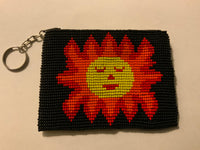 Handcrafted beadwork on both sides of change purse with Sun face.