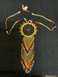 Colorful dreamcatcher in glass bead necklace.